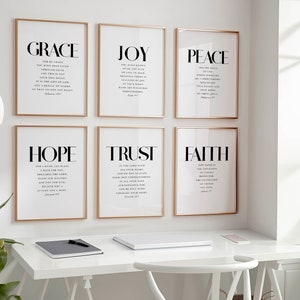 May include: Six framed prints with gold frames, each featuring a different word in large, bold letters: "GRACE", "JOY", "PEACE", "HOPE", "TRUST", and "FAITH". Each word is accompanied by a Bible verse in smaller font.