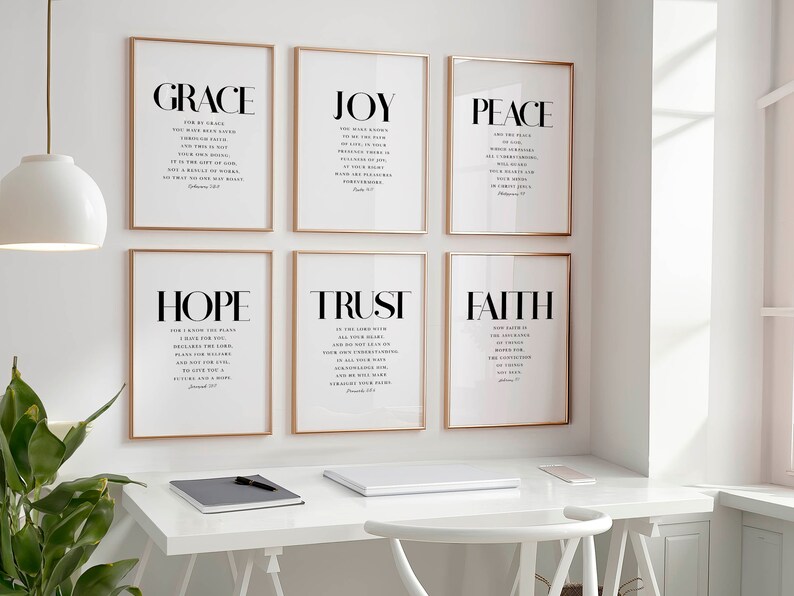 May include: Six framed prints with gold frames, each featuring a different word in large, bold letters: "GRACE", "JOY", "PEACE", "HOPE", "TRUST", and "FAITH". Each word is accompanied by a Bible verse in smaller font.