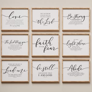 May include: Nine framed wall art prints with inspirational quotes in black script on a white background. The frames are a light brown color. The quotes include "Love," "Be Strong," and "Faith Over Fear."