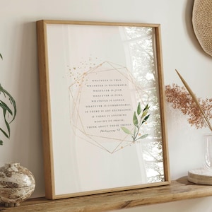 May include: A framed print with a gold geometric design and watercolor leaves. The print features the text "Whatever is true, whatever is honorable, whatever is just, whatever is pure, whatever is lovely, whatever is commendable, if there is any excellence, if there is anything worthy of praise, think about these things." Philippians 4:8
