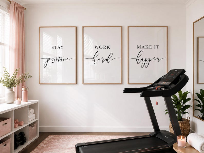 May include: A home gym scene featuring three framed prints with motivational phrases: "Stay Positive," "Work Hard," and "Make It Happen." A black treadmill is in the foreground, with a pink rug and decor adding a touch of color. A mirror and plant complete the space.
