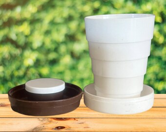 1970s brown and white collapsible travelling drinking cup