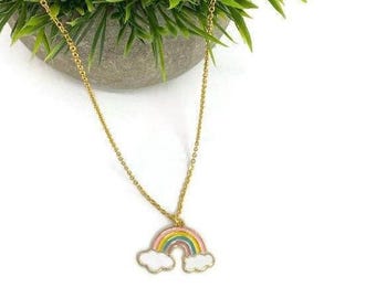 May include: A gold chain necklace with a rainbow and cloud charm. The rainbow is pink, orange, yellow, green, blue, and purple. The clouds are white.