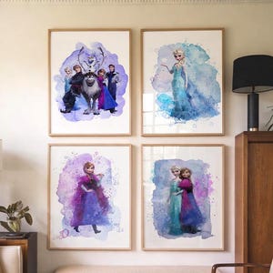May include: Four framed watercolor prints featuring characters from the animated film "Frozen." The prints showcase Elsa, Anna, Kristoff, Sven, and Olaf against colorful, abstract backgrounds. The frames are a light wood color, and the artwork is displayed in a living room setting.