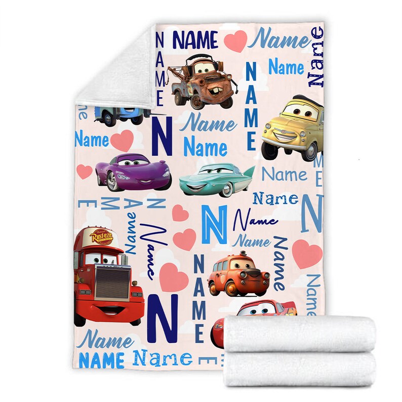 May include: A soft fleece blanket featuring a repeating pattern of characters from the movie Cars, including Mater, Lightning McQueen, and others. The design includes the word Name in various blue fonts, pink hearts, and white clouds on a light background.