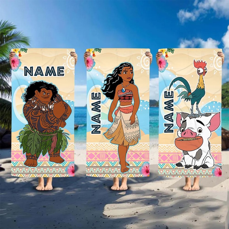 May include: Three rectangular beach towels featuring Moana characters. The first shows a man with tattoos, the second a woman, and the third a rooster and pig. Each towel has a sandy background, floral accents, and the word NAME in dark blue.