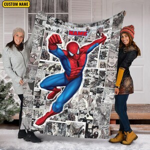 May include: A rectangular throw blanket featuring a large, colorful illustration of Spider-Man in a dynamic pose over a black and white comic book panel background. The blanket includes the red text NAME at the top center and a CUSTOM NAME label.