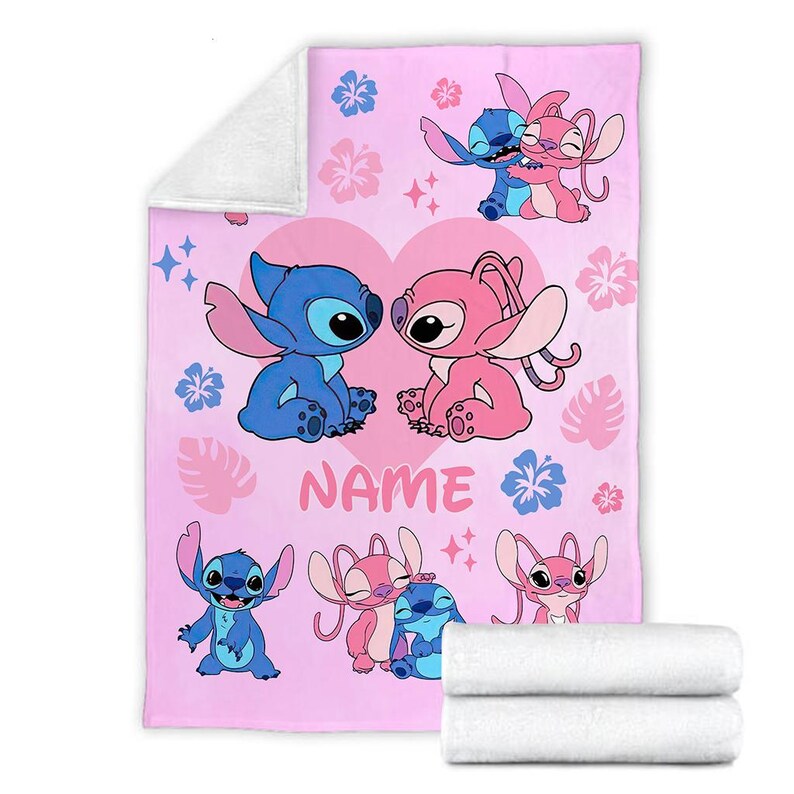 May include: Pink blanket featuring cartoon characters Stitch and Angel, with a heart and floral design. The blanket has a soft, plush texture and includes the word "NAME". Two white rolled towels are at the bottom.