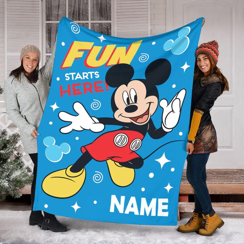 May include: Blue fleece blanket with a cartoon image of Mickey Mouse. The blanket has the text "Fun Starts Here!" and a space for a name.