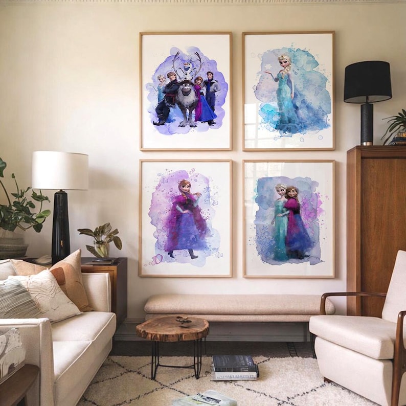 May include: Four framed watercolor prints featuring characters from the animated film "Frozen." The prints showcase Elsa, Anna, Kristoff, Sven, and Olaf against colorful, abstract backgrounds. The frames are a light wood color, and the artwork is displayed in a living room setting.