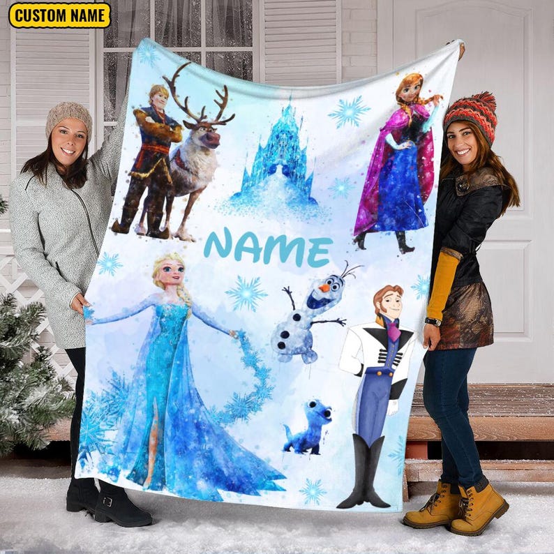May include: A white fleece blanket with a watercolor design featuring characters from the movie Frozen. The blanket features Elsa, Anna, Olaf, Kristoff, and Sven. The blanket also has a blue castle and snowflakes. The text "NAME" is written in blue letters on the blanket.