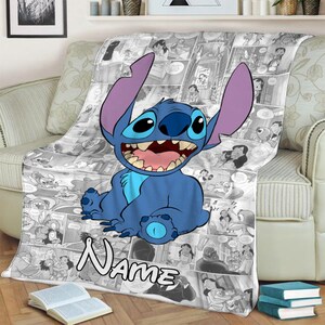 May include: A soft throw blanket featuring a large, blue, alien character with long ears and a wide grin centred over a black and white comic book panel collage. The word "Name" is printed in a bold, white, outlined font at the bottom.