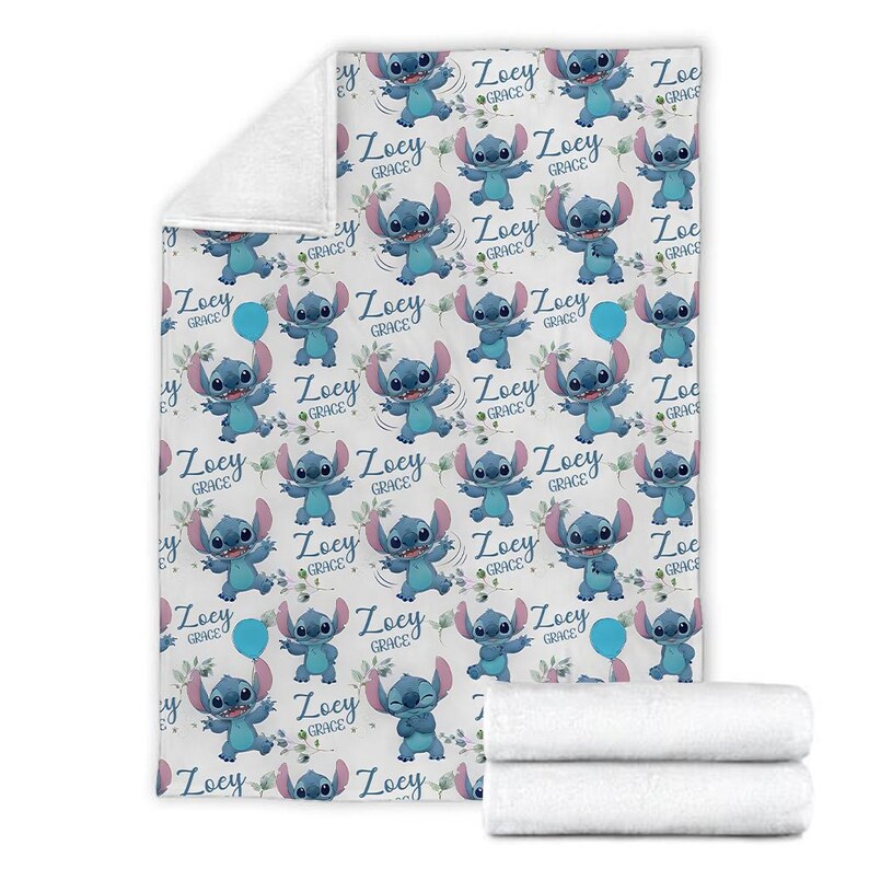 May include: A white fleece blanket featuring a repeating pattern of the blue character Stitch from Lilo and Stitch, interspersed with green leafy sprigs, blue balloons, and the name Zoey Grace written in a dark blue script font throughout the design.