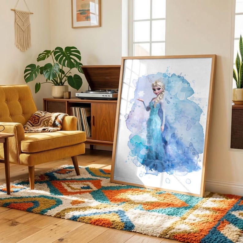 May include: A framed watercolor print of a character in a blue dress with a blue and purple watercolor background. The artwork is displayed in a room with a yellow armchair, a patterned rug, and a wooden cabinet.