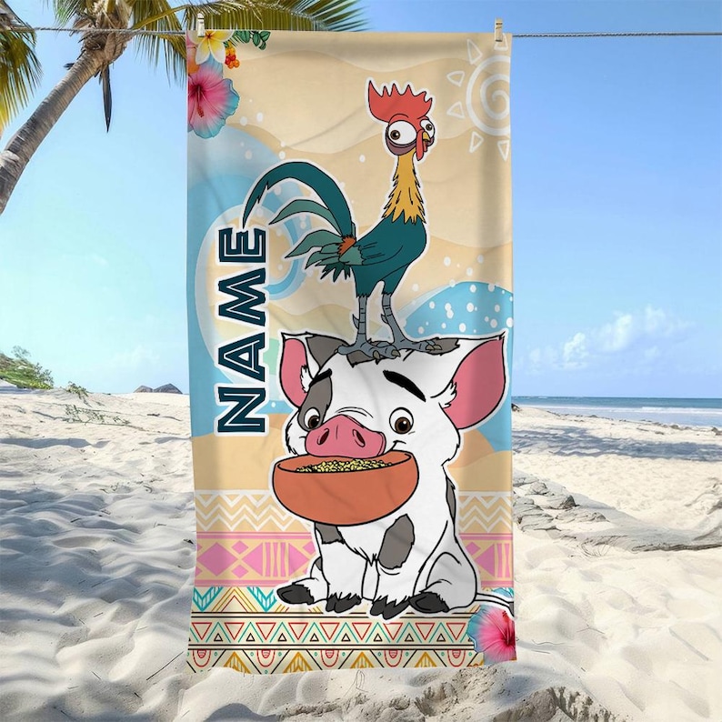 May include: A rectangular beach towel featuring a cartoon rooster standing on a white piglet holding a bowl of food. The background includes tropical flowers, a sun, and geometric patterns. The word NAME is printed vertically in dark blue letters.