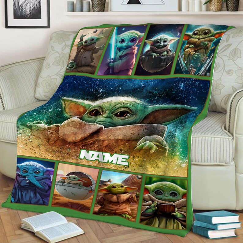 May include: A soft throw blanket featuring a large central illustration of a green alien character with large ears and eyes against a starry background. The design includes seven smaller panels of the same character and the word NAME in white text.