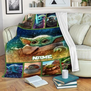 May include: A plush throw blanket featuring a large central graphic of a green alien character with large eyes, surrounded by smaller panels depicting the same character in various poses. The word NAME is printed in white block letters below.