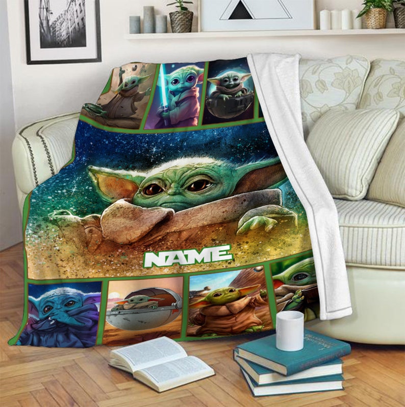 May include: A plush throw blanket featuring a large central graphic of a green alien character with large eyes, surrounded by smaller panels depicting the same character in various poses. The word NAME is printed in white block letters below.