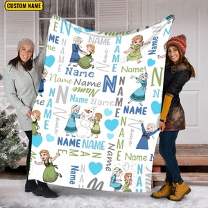 May include: A white fleece blanket featuring a repeating pattern of cartoon characters Elsa and Anna, blue hearts, and the word Name in various fonts and colors including blue, green, and gray. The top left corner displays the text CUSTOM NAME.