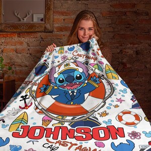 May include: A white and blue personalised blanket featuring Stitch from Lilo & Stitch dressed as a captain. The blanket has a nautical theme with a life preserver, anchor, and seashells. The text "Castaway Cap'n Johnson" is printed on the blanket.