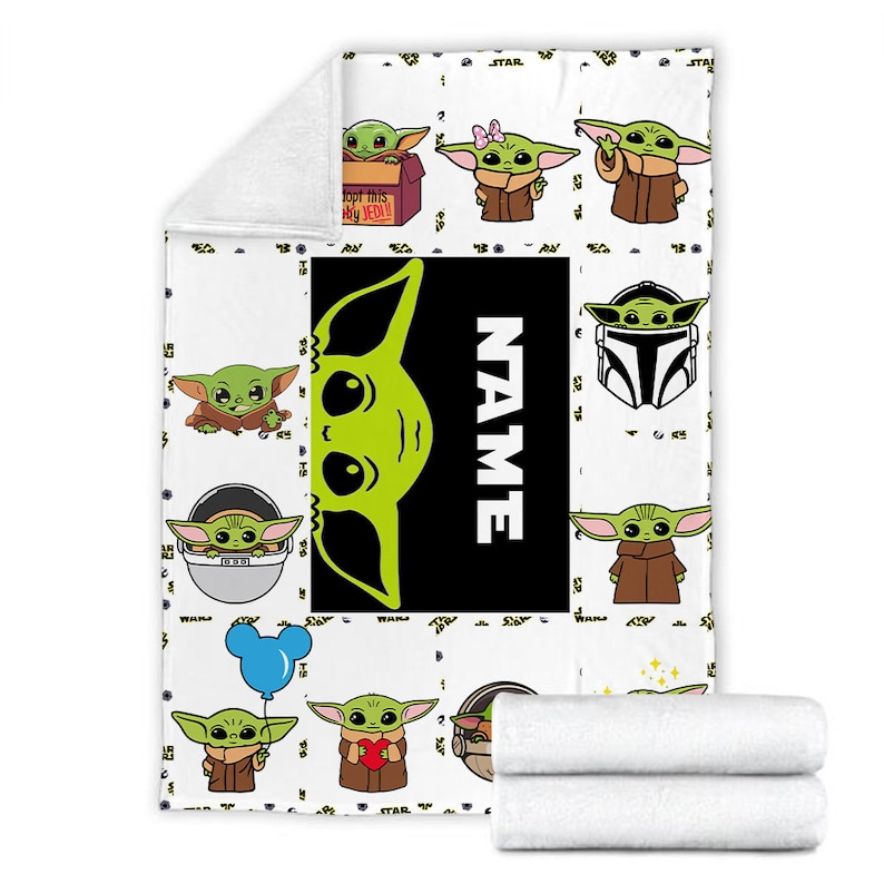 May include: A white fleece blanket featuring a repeating pattern of green alien characters in various poses, including one in a box labeled Adopt this JEDI, one with a pink bow, and one holding a blue balloon. A large black rectangle displays the word NAME.