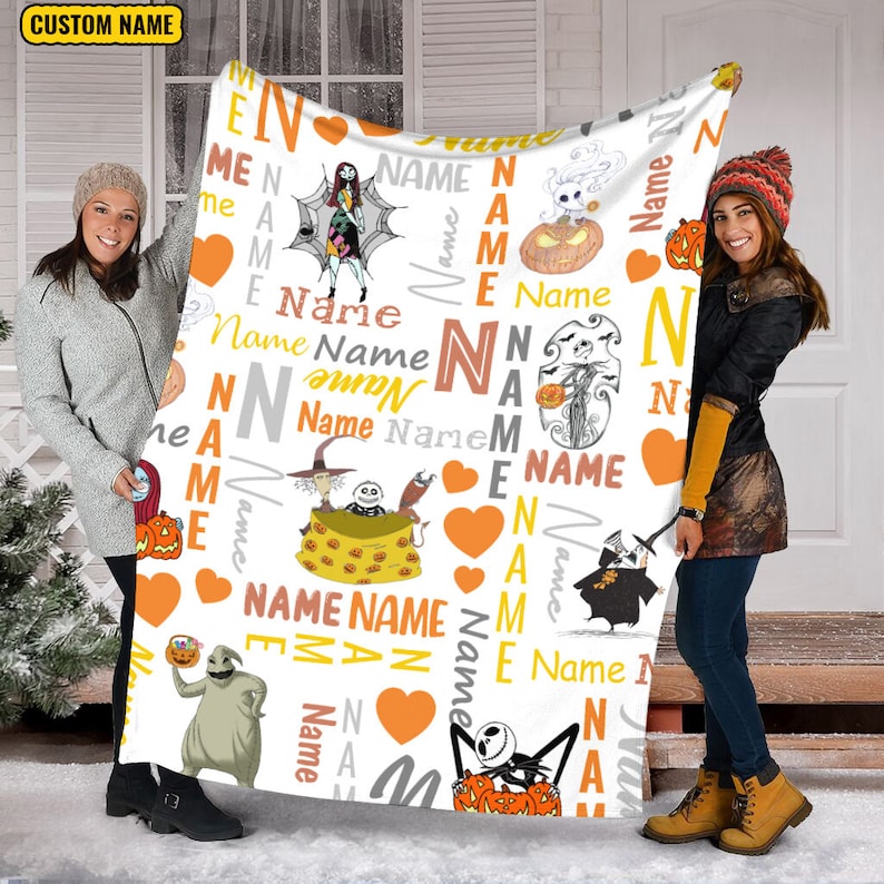 May include: A white fleece blanket featuring a repeating pattern of characters from The Nightmare Before Christmas, orange hearts, and the word Name in various fonts and colors. The blanket includes illustrations of Jack Skellington, Sally, Zero, and Oogie Boogie, along with pumpkins and spiderwebs.