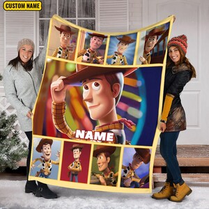 May include: A rectangular fleece blanket featuring multiple panels of the character Woody from Toy Story. The center panel shows a large image of Woody tipping his hat with the text NAME below. The border is yellow with a custom name label.