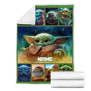May include: A rectangular fleece blanket featuring a large central illustration of a green creature with large ears and dark eyes against a starry space background. The word NAME is printed in white block letters. Seven smaller panels show the creature.