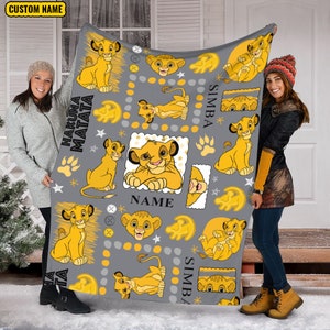 May include: A gray fleece blanket with a repeating pattern of lion cubs from the movie The Lion King. The blanket features the words "Hakuna Matata", "Simba", and "Name".