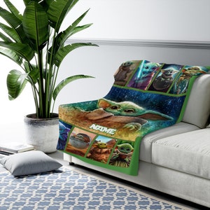 May include: A soft throw blanket featuring multiple graphic panels of a green, large-eared creature in various poses. The center displays a large image of the creature with the text NAME printed in white block letters against a dark blue background.