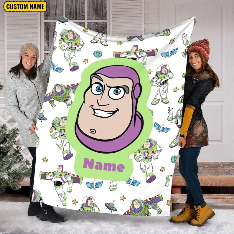 May include: A white fleece blanket featuring a repeating pattern of Buzz Lightyear in various poses, small planets, and stars. A large central graphic displays a close-up of Buzz Lightyear's face inside a green shape with the text Name below it.