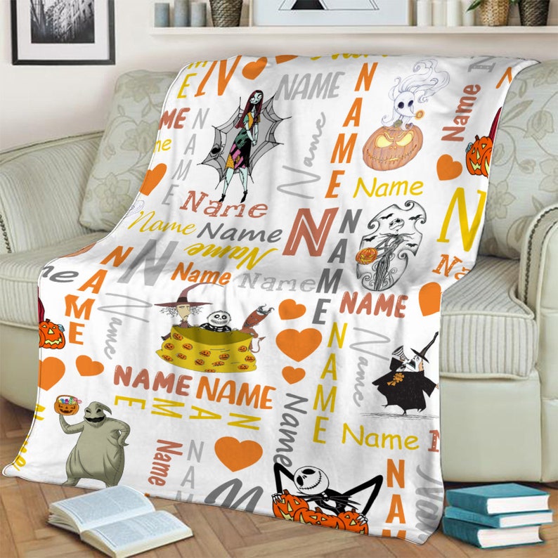 May include: A white fleece blanket featuring a repeating pattern of characters from The Nightmare Before Christmas, including Jack Skellington, Sally, Zero, and Oogie Boogie, interspersed with orange hearts and the word Name in various fonts.