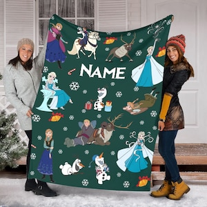 May include: A dark green fleece blanket featuring a repeating pattern of Frozen characters including Anna, Elsa, Olaf, Kristoff, and Sven, interspersed with white snowflakes, gold bells, and candy canes, with the word NAME printed in white.