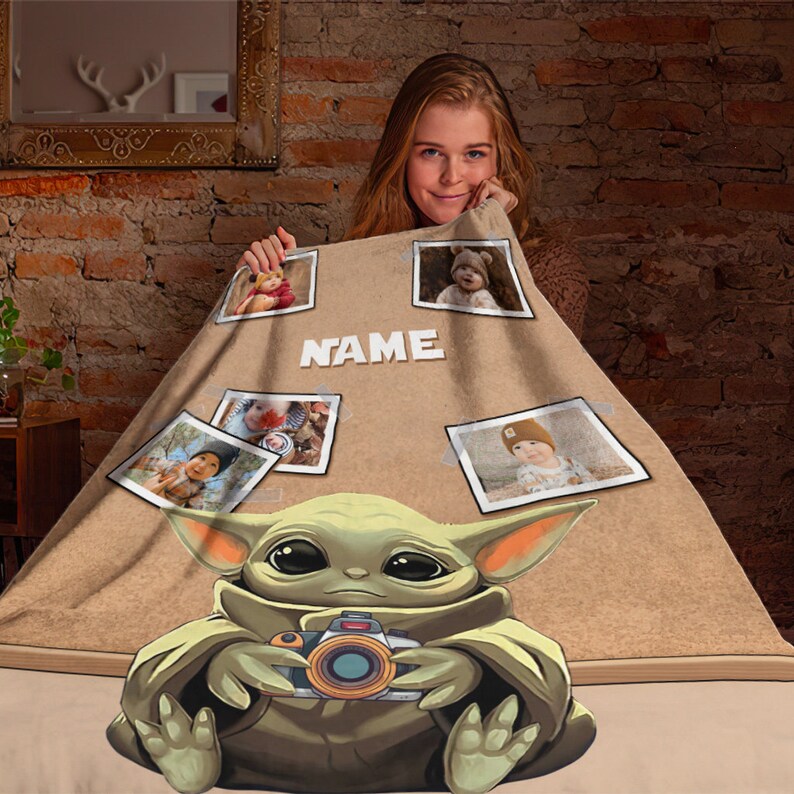 May include: A brown fleece blanket with a cartoon image of a green baby Yoda holding a camera. The blanket has a personalized name and several photo slots.