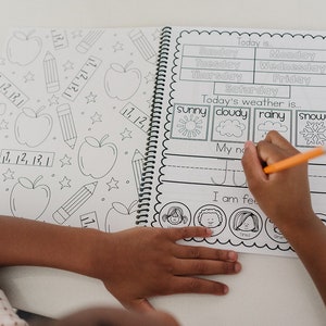 Child working on their personalized workbook. The child is filling out the calendar page and tracing their name.