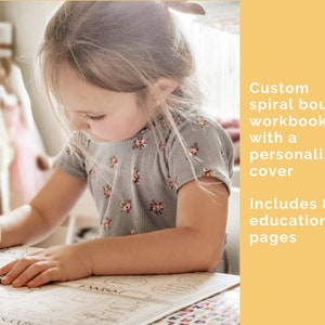 Young girl working on her workbook with words to the side that say custom spiral bound workbook with a personalized cover. Includes 82 educational pages.