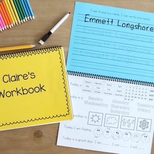 Image has two kindergarten workbook laid out. One is closed so you can see the personalized cover. The other is open to a page that has the childs name to trace and a calendar page with the date weather feelings and affirmations.