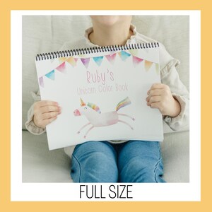 May include: A spiral-bound coloring book titled "Ruby's Unicorn Color Book." The cover features a watercolor illustration of a unicorn with a rainbow mane and tail, and a banner of colorful flags. The words "FULL SIZE" are at the bottom.
