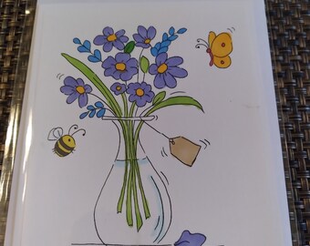 May include: A greeting card with a cartoon illustration of a vase of purple flowers, a yellow butterfly, and a bee. The words "Happy Anniversary" are printed below the illustration. The card is packaged in a clear plastic sleeve.