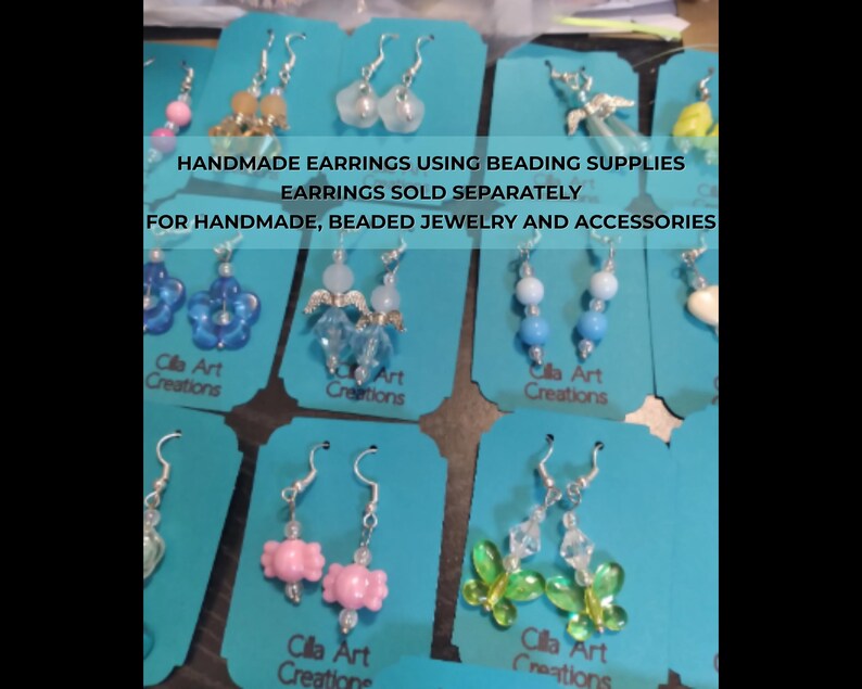 May include: A selection of handmade earrings on teal cards. The earrings showcase diverse designs, such as beaded, floral, and butterfly motifs. The cards display the text "HANDMADE EARRINGS USING BEADING SUPPLIES" and "Cilla Art Creations."