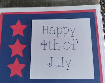 May include: A patriotic greeting card with a red, white, and blue color scheme. The card features three red stars on a blue background, with the words "Happy 4th of July" printed in black.