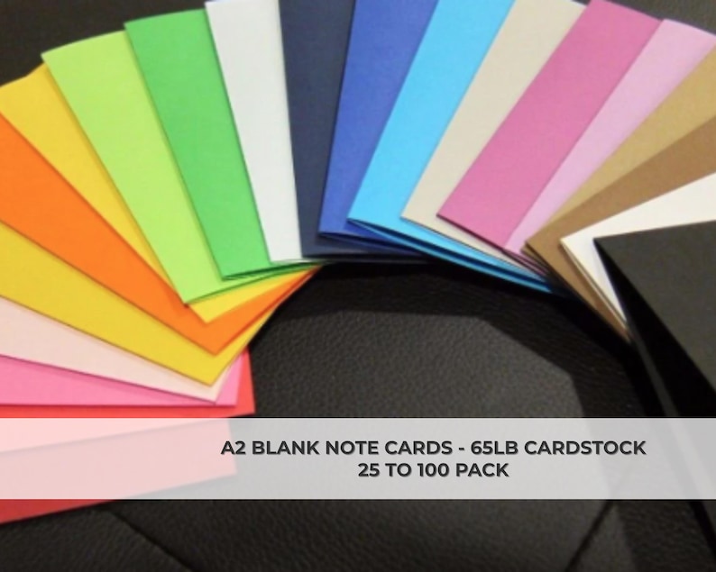 May include: A fan of A2 blank note cards in various colors, including pink, orange, yellow, green, blue, and white. The cards are made of 65lb cardstock and are available in packs of 25 to 100.