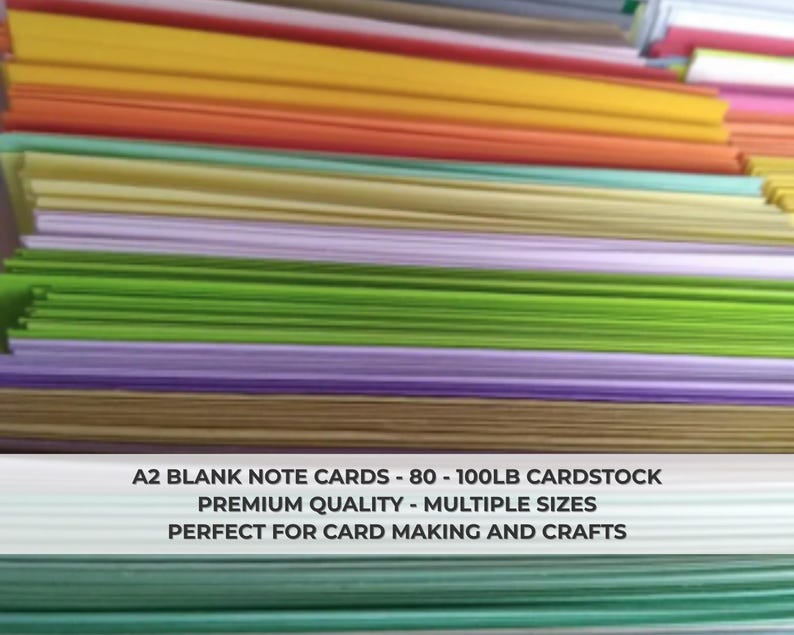 May include: Stacks of A2 blank note cards in various colors, including yellow, orange, green, and purple. The image shows a close-up of the cardstock, highlighting the different hues. The text on the image says "A2 BLANK NOTE CARDS - 80 - 100LB CARDSTOCK PREMIUM QUALITY - MULTIPLE SIZES PERFECT FOR CARD MAKING AND CRAFTS."