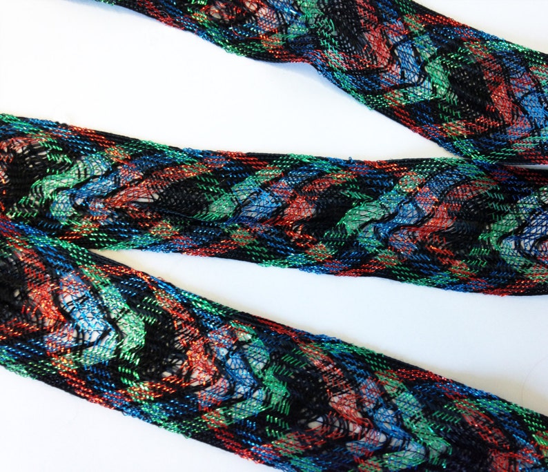 1 3-4th inches wide approx offering lots of 7 yds each. Red loose woven ribbon emerald green and bright blue lurex and black rayon