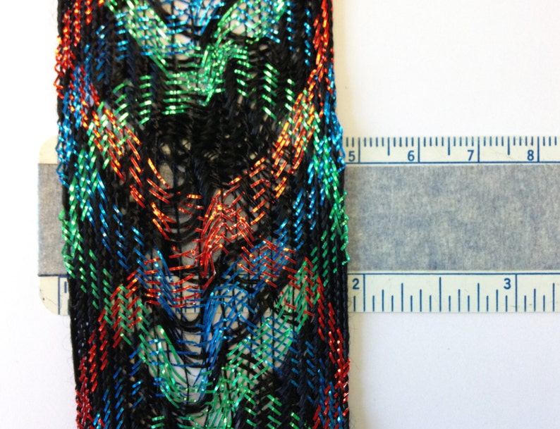 1 3-4th inches wide approx offering lots of 7 yds each. Red loose woven ribbon emerald green and bright blue lurex and black rayon