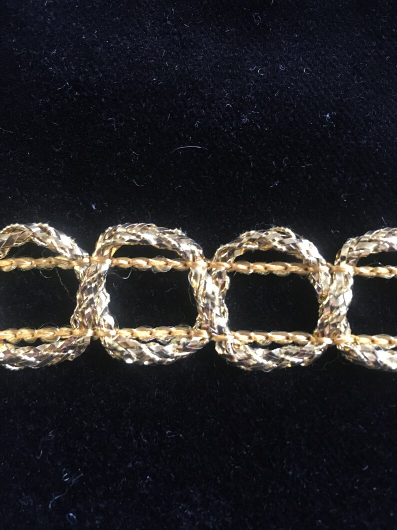 Gold Lurex and Rayon flat trim in a linked circle pattern lots of 12 12 yards 78 wide