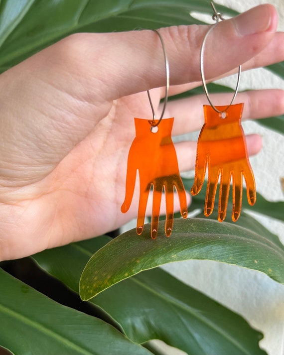 bright orange hand earrings, translucent, carved, 