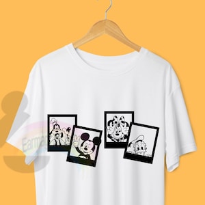 May include: White t-shirt featuring a black and white graphic print of Mickey Mouse and his friends in Polaroid frames.