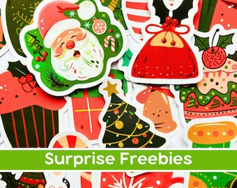 May include: A collection of colorful Christmas-themed stickers. Designs include Santa Claus, Christmas trees, gifts, and ornaments. The text "Surprise Freebies" is displayed in a green banner at the bottom of the image.