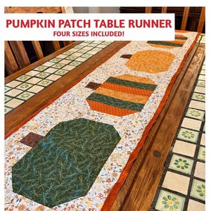 May include: A quilted table runner with a pumpkin patch design. The runner features orange, green, and brown pumpkin shapes on a floral background. The text "Pumpkin Patch Table Runner" and "Four Sizes Included!" are at the top.